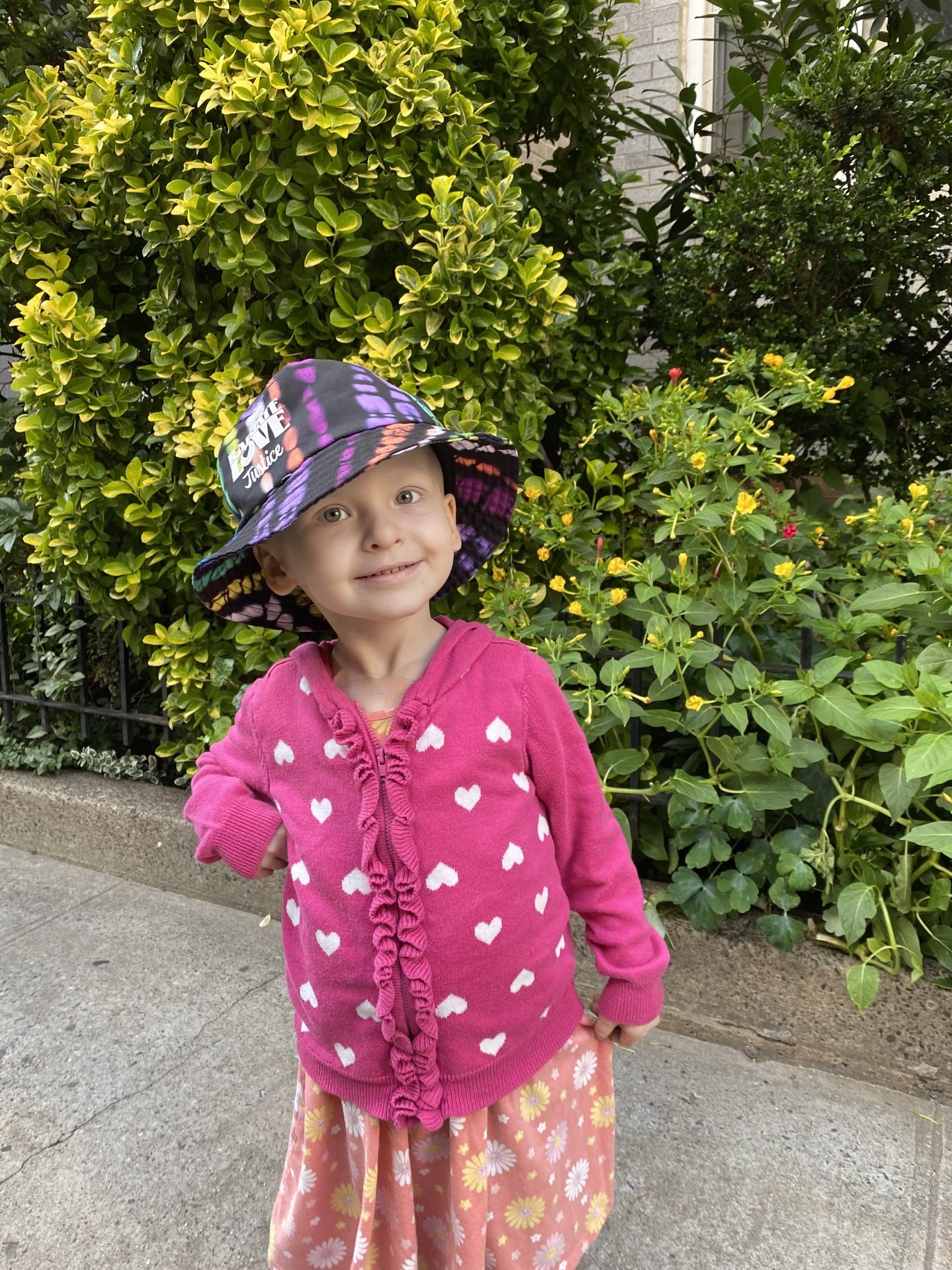 Elayna Grace Sanderson smiling in a garden and wearing pink